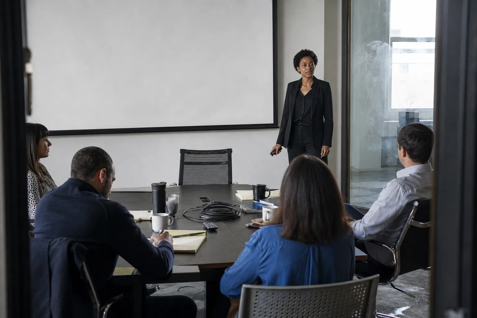 A presenter at a conference table after a joke does not land.